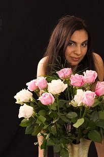 Girl smiling behind flowers