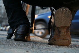 Man showing bottom of his shoes